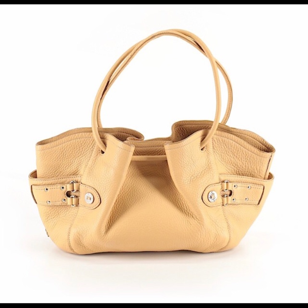 Camel colored Cole Haan purse with a pink lining